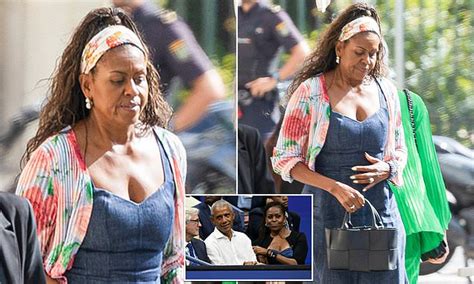 Michelle Obama Looks Somber As She Models A Low Cut Denim Dress For