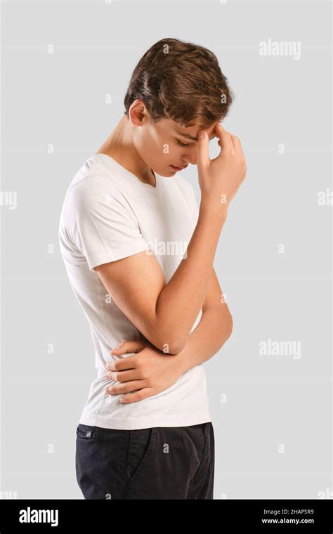 Young Man Bowed His Head And Touching Forehead Standing In Profile