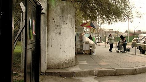 Food Vendor With Colourful Umbrella Over His Portable Cart At The