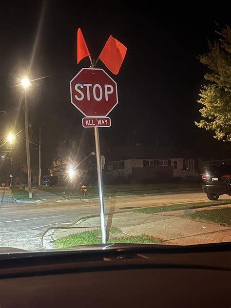 Orange flags attached to new stop signs by my house disappear, then