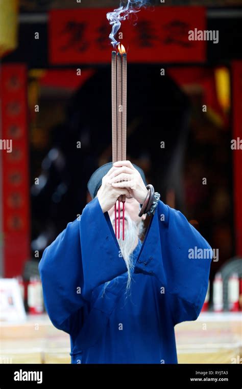 Taoist Mission Old Priest Praying With Incense Sticks Singapore