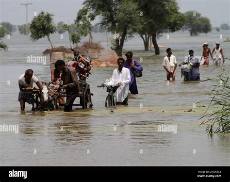 Pakistani Flood Survivors Wade Through Floodwater Toward Safer Areas In