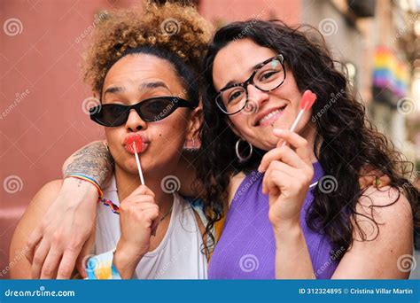 Lesbian Couple Are Holding Heart Lollipops And Smiling At Camera Stock Image Image Of City