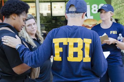 Download Fbi Agents In Uniform Standing Outside A Restaurant Wallpaper