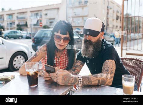 Mature Hipster Couple Looking At Smartphone At Sidewalk Cafe Valencia Spain Stock Photo Alamy