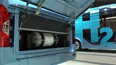 A hydrogen fuel cell buses. One bus with an open hood and a hydrogen cylinder inside. Stock ...