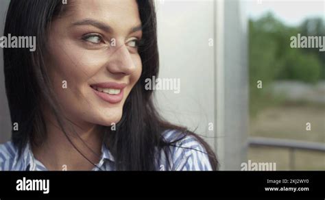 Portrait Of Charming Brunette Looking And Smiling Into Camera With Blowing Hair Stock Video