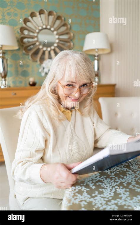 Portrait On A Beautiful Old Lady In Glasses Reading A Book. Elegant ...