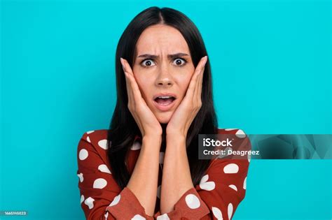 Portrait Of Speechless Confused Lady Arms Touch Cheeks Open Mouth Staring Isolated On Emerald