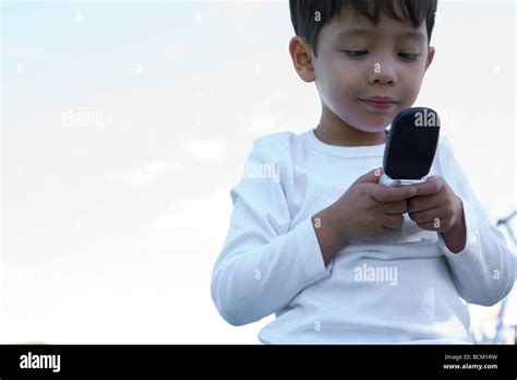 Boy Using Cell Phone Low Angle View Stock Photo Alamy