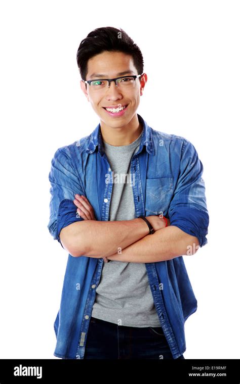 Portrait of a young smiling asian man with arms folded over white ...