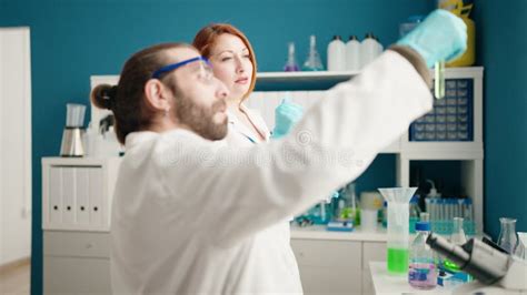 Man And Woman Scientists Using Touchpad Working At Laboratory Stock