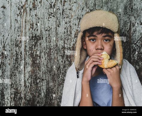 Hungry Child Eating Bread That Asking Help For Food Donation From The