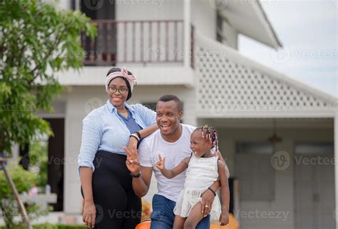 Cheerful african american family with luggage leaving house for ...