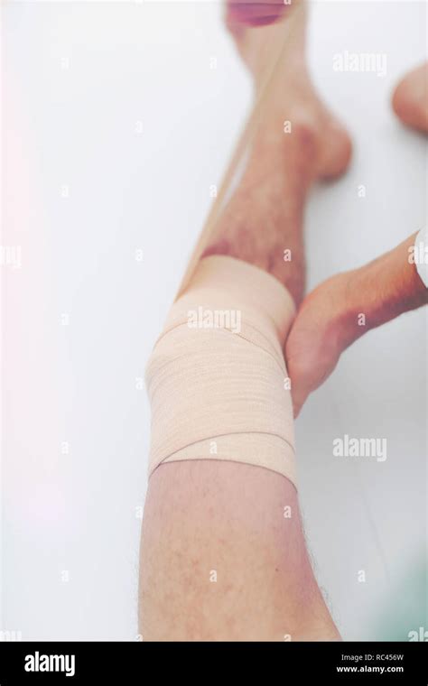 Closeup Doctor Bandaging A Patient S Leg Stock Photo Alamy