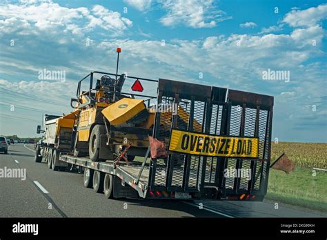 Heavy Duty Truck Pulling A Flatbed Trailer Hauling A Etnyre Chip