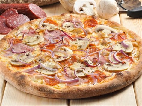 Premium Photo Tasty Pizza With Ham And Mushrooms On A Wooden Board