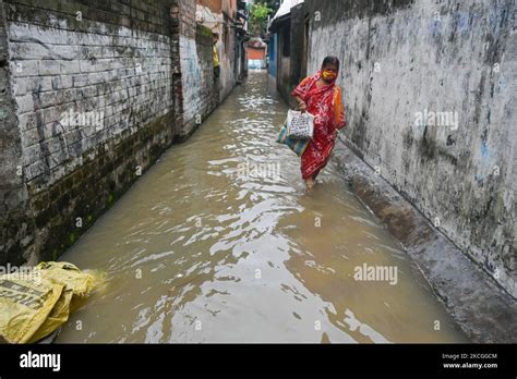 A Lady Makes Her Way Through A Flooded Lane In Kolkata India On 26