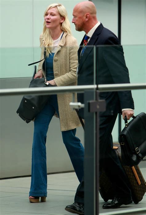 Kirsten Dunst - Catching a flight at London Heathrow Airport - August
