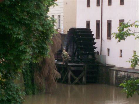 there is a man that is standing in the water next to a building and stairs