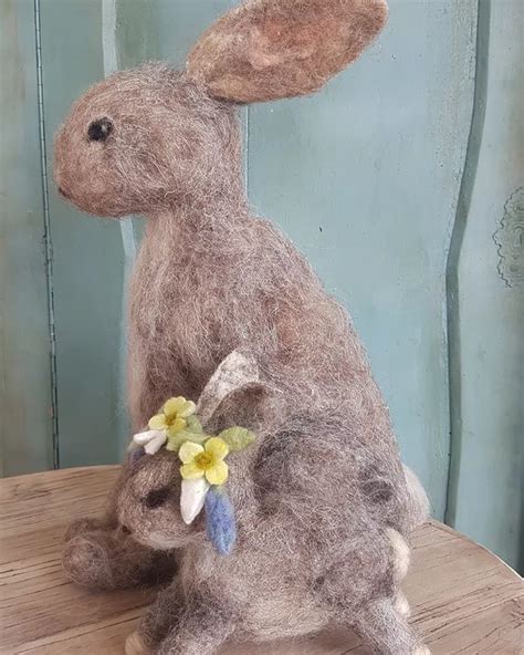 A Stuffed Rabbit Sitting On Top Of A Wooden Table