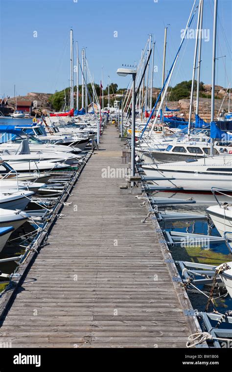 Long Pier With Boats Moored In The Marina Stock Photo Alamy