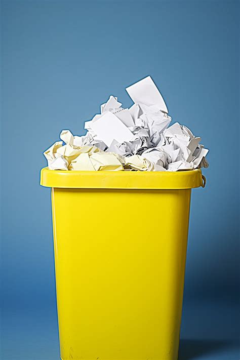 Yellow Paper Recycling Bin With Trash In It Background Wallpaper Image