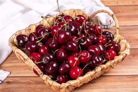 Premium Photo Fresh Cherry Ripe Cherries In A Basket On Wood