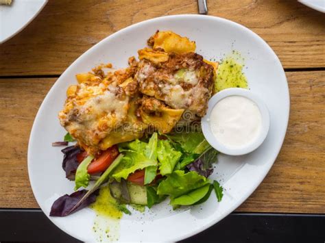 Tasty Serving Of Traditional Italian Lasagne With Spicy Tomato Based