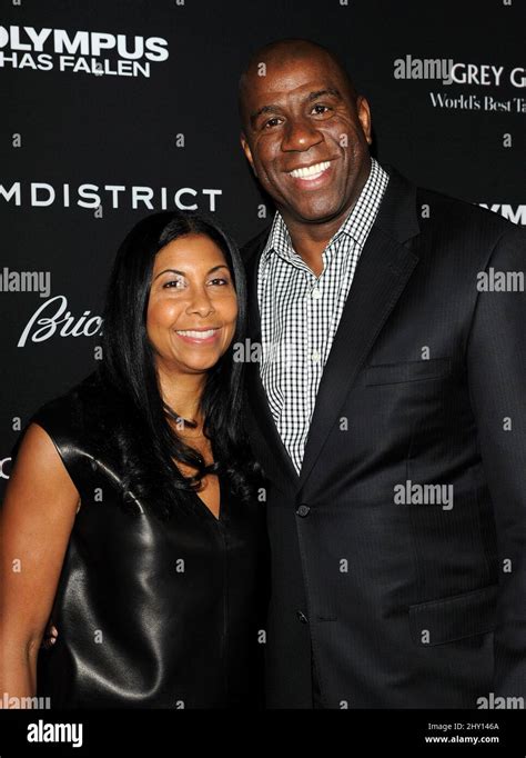 Magic Johnson And Wife Cookie Attending The Premiere Of Olympus Has