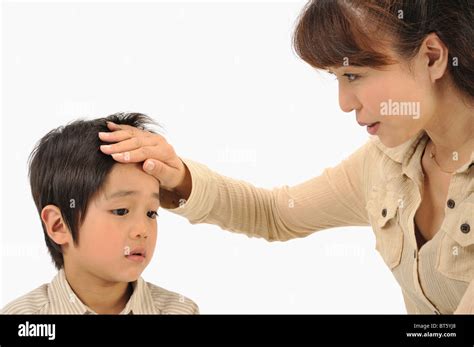 Mother Touching Son S Forehead Stock Photo Alamy