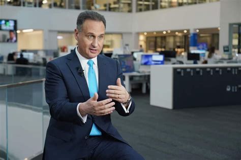 a man in a suit and tie sitting down