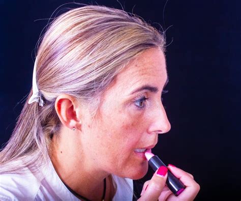Blonde Lady Does Her Own Makeup Accentuating Her Lips Stock Photo Image Of Blond Locks
