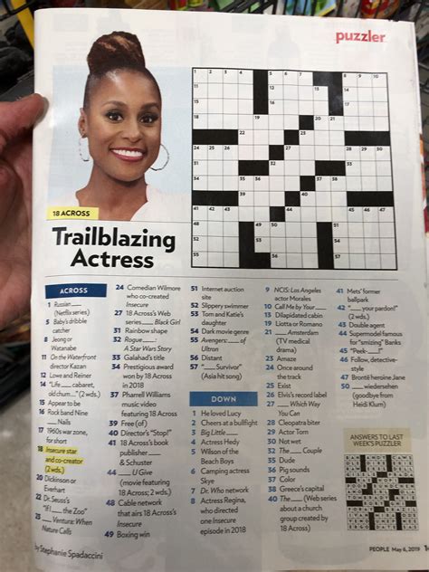 A Crossword Puzzle Is Being Held Up By Someone