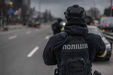 Ukrainian Police Officer In Uniform Patrolling Streets By Stocksy