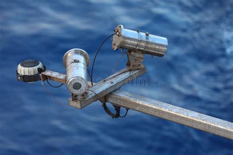 Side View Of An Outdoor Mounted Security Camera With Sky Clouds And