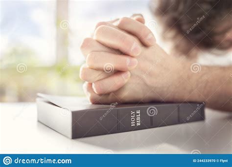 Hands Folded In Prayer On A Holy Bible In Church Faith Spirtuality