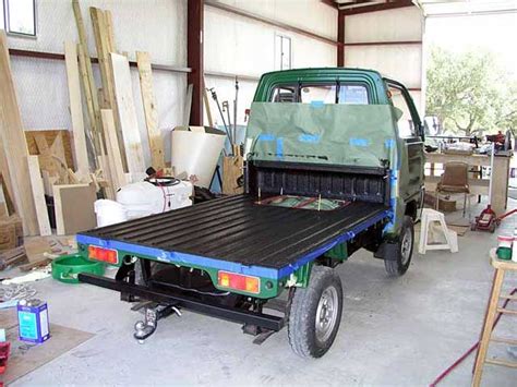 A Green Truck Parked Inside Of A Garage