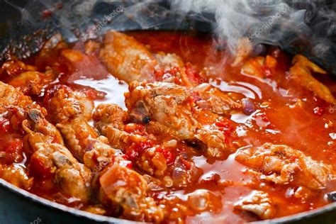 Stewed chicken in tomato sauce Stock Photo by ©igorr1 70123803