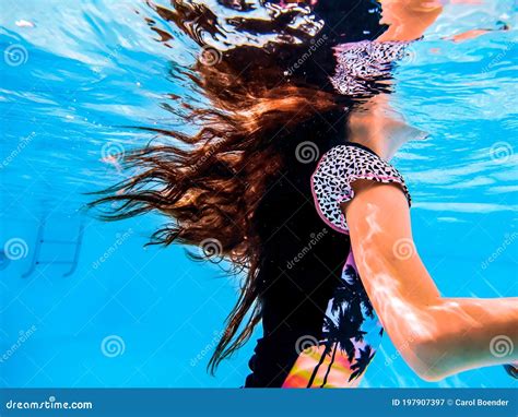 A Girl`s Long Hair Flowing Underwater And Reflections On The