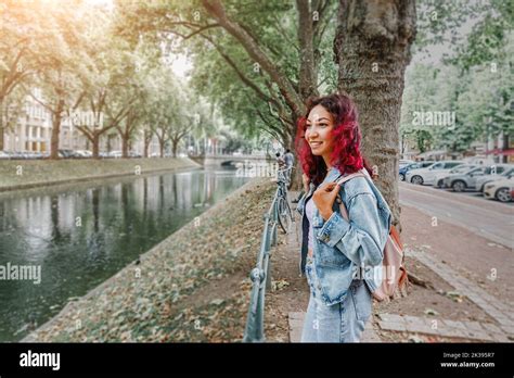 Happy tourist woman with backpack standing near Konigsallee water ...