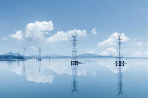 Premium Photo Electricity Transmission Pylon On Lake And Reflection