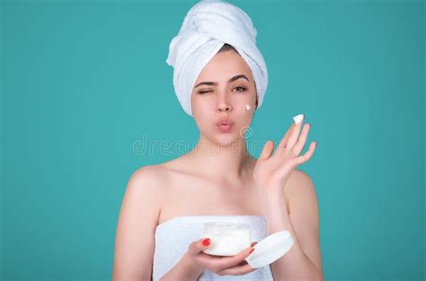 Skin Care Beauty Portrait Of A Beautiful Woman Applying Face Cream