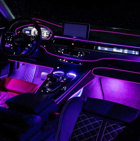 The Interior Of A Car With Purple Lighting