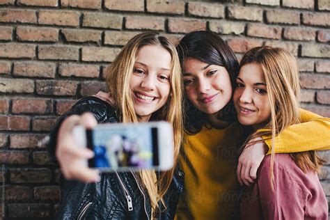 Teen Girls Taking A Selfie With Their Phone By Stocksy Contributor