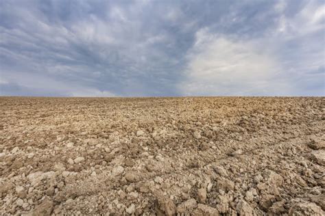 Agriculture Soil Empty Farmland Field And Clouds Sky Background Stock