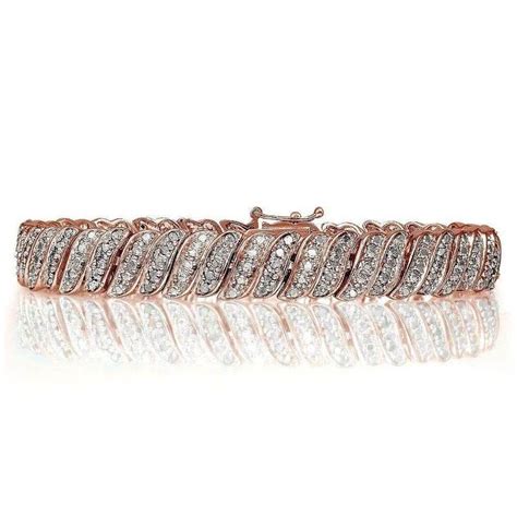 A Rose Gold Bracelet With Rows Of Diamonds On The Front And Sides Set