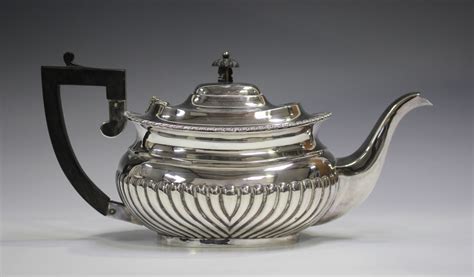 A Late Victorian Silver Teapot Of Half Spiral Reeded Cushion Form With