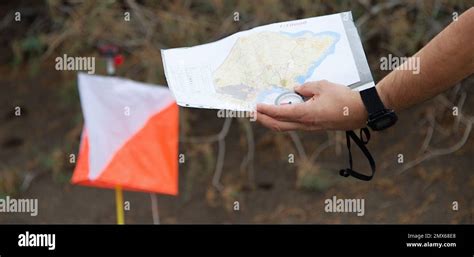 Man Holding Mapathlete Uses Navigation Equipment For Orienteering