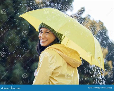 Raincoat In Rain And Umbrella